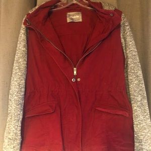 Burgundy jacket with gray sleeves and hood.